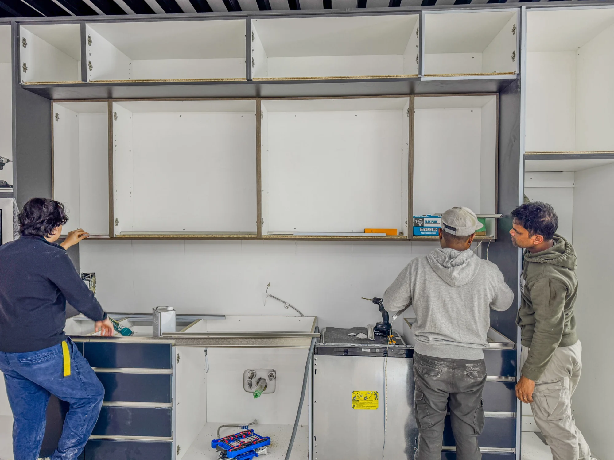 Tevola installers fitting upper and lower cabinets on site